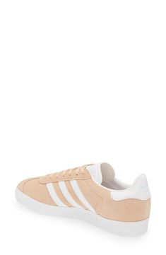 Initially designed as a training shoe for top athletes in 1991, adidas' iconic Gazelle sneaker has been refreshed with a sleek, narrower silhouette but retains the classic contrasting 3-Stripes and heel tab of the original, and is presented in throwback archival hues. Lace-up style Cushioned footbed Removable insole Leather or leather and synthetic upper/textile and synthetic or synthetic lining/synthetic sole Imported BP. Shoes Adidas Low-top Skate Shoes With Contrast Sole, Adidas Synthetic Skate Shoes With Gum Sole, White Sole Sneakers With Gum Sole, Adidas Urban Sneakers With Gum Sole, Athleisure Lace-up Sneakers For Skateboarding, Adidas Sneakers With Gum Sole, Adidas Gazelle Sneaker, Down To Earth, Adidas Samba Sneakers