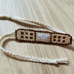 two beaded bracelets sitting on top of a wooden table