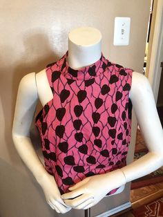 This classy and gorgeous Ankara Blouse is a show stopper for all occasions. Pair it with wide leg pants for a classy look. Bishop style collar with cut out at the shoulder . Color-Pink and brown Size- Medium Cropped Cutout Tops For Party, Chic Cutout Crop Top, Chic High Neck Crop Top For Summer, Chic Sleeveless Cutout Crop Top, Chic Sleeveless Crop Top With Cutout, Sleeveless Cotton Tops For Date Night, Trendy Fitted Sleeveless Crop Top, Spring Sleeveless Cutout Crop Top, Spring Sleeveless Crop Top With Cutout