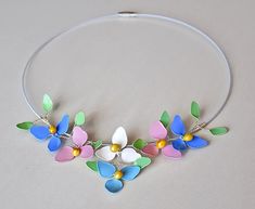 Necklace with floral motifs in delicate pastel colors. A wonderful gift for you or a loved one. The colors are pale blue, pink and white, surrounded by leaves in a gentle green. They are made of wire and lacquer jewelry. In the middle of the flowers there is a stamen made of cotton fiber, polymer clay and lacquer. The base of the necklace is made of white cord for jewelry with a length of 46 cm. Each flower is 2.5 x 2.5 centimeters in size, and the total size of all flowers is: length 13.00 cent Nail Polish Flowers, Wire Jewelery, Floral Banners, Floral Drawing, Nails Polish, Floral Backdrop, Dark Floral, Floral Garden, All Flowers