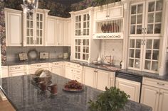 a large kitchen with marble counter tops and white cabinets