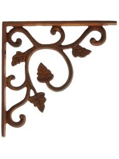 an ornate wooden shelf bracket with leaves and scrolls on the top, against a white background