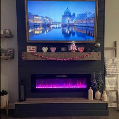 a living room with a fire place and christmas decorations on the mantel above it