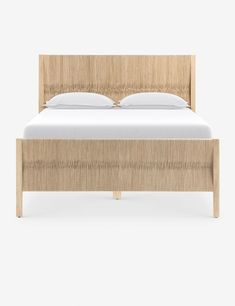 the bed frame is made from wood and has white sheets