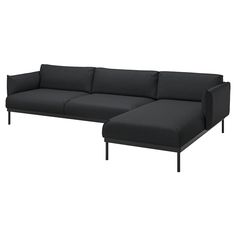 a black sectional sofa sitting on top of a white floor