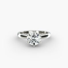 a white gold engagement ring with a single diamond in the center, on a white background