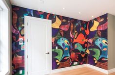 a colorful wallpapered room with an open door