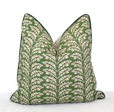 a green and white pillow sitting on top of a table