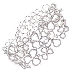 Platinum Diamond Paper Flowers Wide Bracelet by Tiffany & Co. The Tiffany & Co Paper Flowers Bracelet is a stunning piece crafted in platinum. It features an intricate floral design encrusted with dazzling diamonds. This wide bracelet embodies elegance and sophistication, showcasing Tiffany's renowned craftsmanship. Authentic and luxurious, it is a timeless addition to any jewelry collection. Retails Approx $100,000 With Round Brilliant Cut Diamonds VS1 clarity, G color approximately 12ct Detail Modern Bangle, Tiffany And Co Bracelet, Tiffany Diamond, The Crown Jewels, Hermes Jewelry, Modern Bracelets, Aquamarine Necklace, Wide Bracelet, Sapphire Bracelet