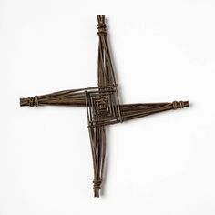 a cross made out of sticks on a white surface