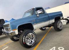 a large blue truck parked in a parking lot