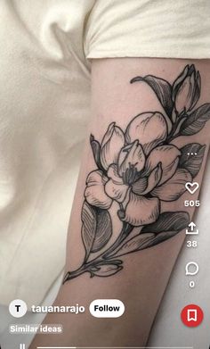 a black and white flower tattoo on the arm