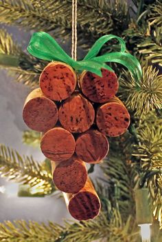 a christmas ornament made out of wine corks hanging from a pine tree