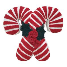 a pair of red and white striped mittens with holly decorations on the top,