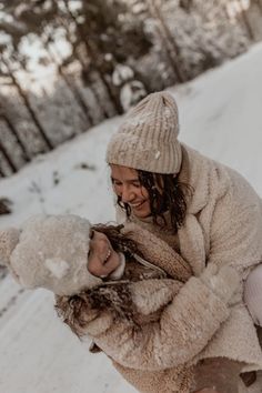 two girls are playing in the snow together