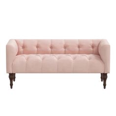 a pink couch sitting on top of a white floor