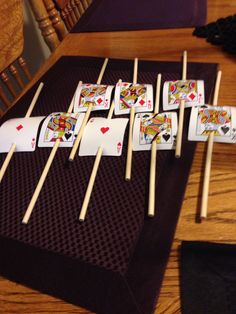 playing cards on sticks are sitting on a table