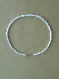 "This White Beaded Choker is so simple and elegant. It can wear alone or layer with other chokers, in any case, it is perfect for any outfit. This listing for ONE WHITE CHOKER. DETAILS - Japanese glass seed beads 4 mm - Quality strong nylon string - Choker length. Choose in the drop down menu - Lobster or round clasp closure. Available gold tone (default) or silver tone (by request) - Extension (adjustment) is 1 inch (2.5 cm). If you need longer, please, leave a note when ordering - Comes in a s White Choker Necklace, Summer Choker, White Choker, Seed Bead Choker, White Beaded Necklaces, Beach Necklace, Bridal Choker, Minimalist White, Bead Choker