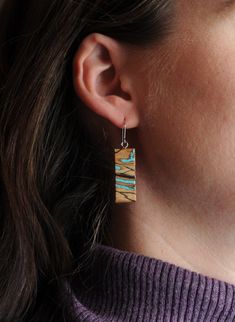 These modern rectangle bar earrings are handcrafted from natural sugar Maple with a organic abstract spalting, inlaid with genuine Turquoise chips. Finished with hypoallergenic surgical steel or sterling silver findings. Hypoallergenic, very lightweight, and tarnish resistant. These earrings are sold as one pair and each one will have slight variations in the woodgrain/pattern, tone, and shape of the inlay, please see all of the photos to get an idea of the variations you might receive. I am happy to send photos of some available pair if you message me. Each piece is hand cut and inlayed by Josiah Eidmann in Kenosha, WI. Woodgrain Pattern, Organic Abstract, Spalted Maple, Sugar Maple, Real Turquoise, Natural Sugar, Lightweight Earrings, Genuine Turquoise, Bar Earrings