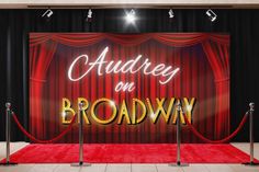 a red carpeted area with an advertisement for broadway