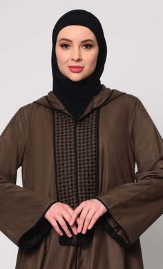 Elevate your modest fashion with our Hoodie Abaya, where contemporary style meets traditional elegance. Crafted from high-quality fabric, this abaya features intricate check embroidery, adding a touch of sophistication. The front is adorned with charming tassels that sway gracefully with your movements, creating a dynamic silhouette. Designed for both comfort and style, it includes two practical pockets, perfect for keeping essentials close at hand. Whether worn casually or for special occasions Hoodie Abaya, Abaya With Pockets, Check Embroidery, Brown Hoodie, Modest Fashion, Black Hoodie, Ankle Length, Contemporary Style, Quality Fabric