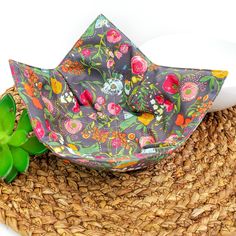 an umbrella sitting on top of a wicker mat next to a green succulent