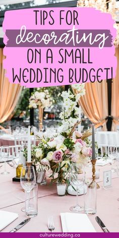 a table set up for a small wedding with pink and white flowers on the center