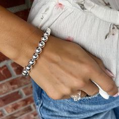 Every girl needs the classics... Our Classic Bead Bracelet comes to you in sterling silver with a magnetic closure and added secure safety chain. The generously sized beads measure approximately 9mm in diameter and create a look that is bold enough to wear alone or, if silver shine in layers is your style, can be stacked up with your favorites. The easy hidden closure contains a magnet that makes it a breeze to slip on or off. Available in 2 sizes:Standard (7.5 inches)Large (8.0 inches) for a sm Magnetic Silver Round Jewelry, Classic Silver Beads Stretch Bracelet For Everyday, Classic Adjustable Sterling Silver Stretch Bracelet, Trendy Silver Stretch Bracelet With Round Beads, Elegant Sterling Silver Stretch Bracelet With Silver Beads, Everyday Silver Bead Stretch Bracelet, Elegant Silver Stretch Bracelet With Polished Beads, Elegant Silver Stretch Bracelet For Everyday, Hypoallergenic Sterling Silver Stretch Bracelet In Silver