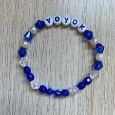 a blue and white beaded bracelet with the word yok on it