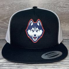 Our 3d Pvc Patch Is A Waterproof, Rugged, And Clean Looking Design. You Can Bet That This Patch Will Look Vibrant For Years To Come. We Only Use The Highest Quality Products And Headwear. We Believe That Our Pvc Patches Beat Out Any Other Type Of Patch Offered On A Hat. Design: Uconn Huskies Hat: Yp Classics Flat Bill Trucker Cap Color: Black/ White 65/35/1 Polyester/Cotton/Spandex Matching Undervisor Structured, High-Profile, Five-Panel Mesh Back, Snapback Closure Crown Height: 3 1/2" Hat Size: Black One Size Fits Most Baseball Cap For Fans, Casual Black Trucker Hat For Fans, Casual Black Trucker Hat For Fan Merchandise, Black Hat With Custom Logo For Baseball Season, Black Baseball Cap With Visor For Fans, Black Hats With Custom Logo For Sports Events, Black Trucker Hat With Flat Bill For Game Day, Black Casual Snapback Hat With Custom Logo, Black Visor Baseball Cap For Fans