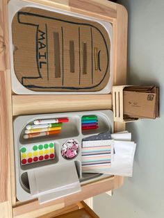 a wooden desk with various stationery items on it