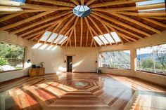 the inside of a house with wood floors and wooden ceiling beams that have been made out of plywood