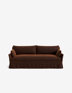 a brown couch sitting on top of a white floor