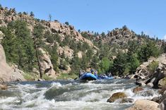 a group of people are rafting down a river