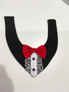 a black and white collar with a red bow tie