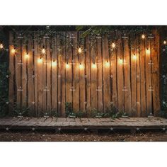 a wooden fence with lights on it