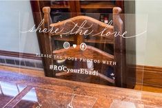 a chair that is sitting in front of a glass case with the words share the love on it