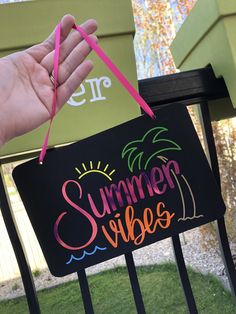 a hand holding a sign that says summer vibes