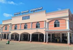 an old pink building with columns and arches