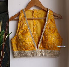 This Made to Order/Made to Measurement/Custom Made Indian Ethnic Blouse. - Fabric - Gold Embroidered Silk - Color - Amber Yellow - Padded - Princess Cut - Plunge Neckline - Lined - Sleeveless - Borders around the waist and Neckline - Extra margin and extra stitches included in the blouse PLEASE NOTE: BUYERS ARE RESPONSIBLE FOR ANY CUSTOMS AND IMPORT TAXES THAT MAY APPLY. This is a made to order product. If you opt for 'Made To Measurement Option', we will provide a measurement template and you can share the measurements likewise. If you want to opt for 'Standard Size', Please refer to the size chart provided in the listing. Shipping: Standard Shipping is done by DHL ecommerce and it mostly takes 2 to 3 weeks to deliver after dispatch. Express Shipping is done by DHL express and it mostly d Luxury Yellow Unstitched Blouse, Luxury Semi-stitched Yellow Blouse, Cheap Yellow Blouse Piece For Diwali, Cheap Yellow Semi-stitched Blouse, Blouse Design For Big Bust, Fitted V-neck Lehenga With Zari Work, Festive V-neck Choli With Mirror Work, Traditional V-neck Choli With Intricate Embroidery, Embroidered Fitted V-neck Choli