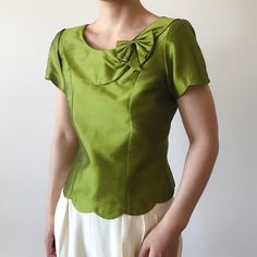 Vintage satin blouse, yellow-ish green color. Looks like a handmade piece, zipper in the back for closure.  Excellent vintage condition Material: No material tag, feels like synthetic some kind.  Size like XS/S. Model is 5'5'', 128 lbs, usually US size 5 Flat measurements: bust: 17'' (34'' around) length: 19'' Follow us on Instagram (oldgemvintage) for more choices! Please ask me about international combined shipping.  Please check the flat measurements before purchase since all sales are FINAL. Except it is mistake on my part, in which case I will refund the purchase. I do my best to examine the garments but make mistakes sometimes, please let me know if that is the case. Thank you so much!  Please note that these are vintage clothing, and they may have slight signs of wear. I try my best Vintage Green Formal Tops, Vintage Green Silk Top, Formal Green Summer Tops, Green Formal Summer Tops, Green Formal Top For Summer, Vintage Green Blouse For Party, Fitted Green Top For Formal Occasions, Green Fitted Top For Formal Occasions, Vintage Spring Blouse With Bow