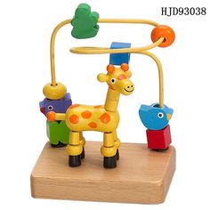 a toy giraffe is standing on a wooden stand