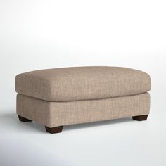 a small footstool sitting on top of a white floor next to a wall