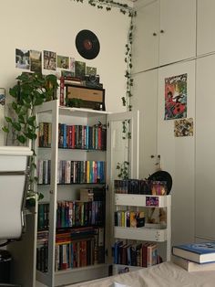 a book shelf filled with lots of books next to a toilet