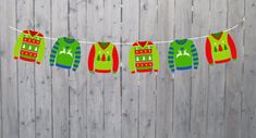 christmas sweaters are hanging on a clothes line