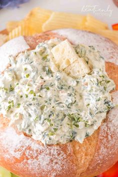 a bagel filled with cheese and spinach dip