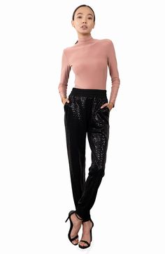 Preorder If Your Size Is Not Available. We'll Ship Within 7-10 Days. Styling: The Agape sequin pants add a generous dose of glamour from day to evening. The relaxed shape is ultra-modern and can be worn in many different ways, teamed with a tee and flat shoes or sneakers for a more casual day look. Alternatively, wear with a more formal top and heels for a chic evening look. We have also teamed them here with the matching glam hoodie ( enquire with our agent regarding its availability) for a str Dressy Sweatpants, Sequin Joggers, Sequin Jogger Pants, Formal Top, Formal Tops, Sequin Pants, Black Sparkle, Ultra Modern, Glam Dresses