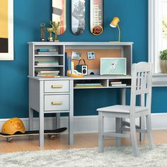 a desk and chair in a room with blue walls