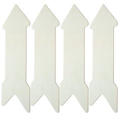 four white plastic arrows on a white background