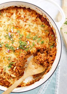 a casserole dish with meat, cheese and herbs in it on a table